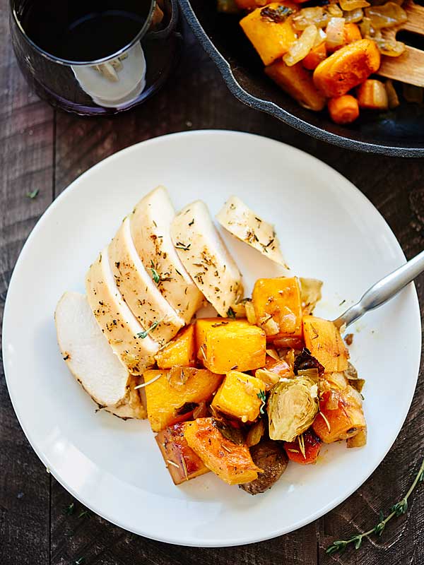 chicken and roast veggies on plate above