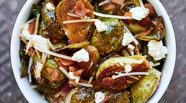 This Roasted Brussels Sprouts Recipe is smothered in a bacon fat, maple syrup, balsamic vinegar dressing and tossed with goat cheese, parmesan, and bacon! showmetheyummy.com #brusselssprouts #thanksgiving