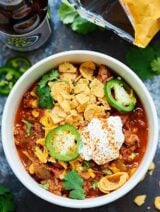 This Slow Cooker Beef Chili is a quick & easy fall dinner! Beef, beer, liquid smoke, vegetables, & spices cook low & slow for a really flavorful dish! showmetheyummy.com #beefchili #slowcooker