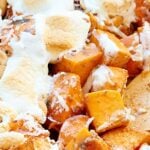 This unique sweet potato casserole is full of roasted sweet potatoes, cashews, coconut, and marshmallows and is smothered in a brown sugar, cinnamon, butter sauce! showmetheyummy.com #thanksgiving #sweetpotatocasserole