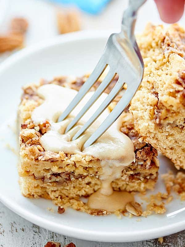 fork in piece of coffee cake with maple icing