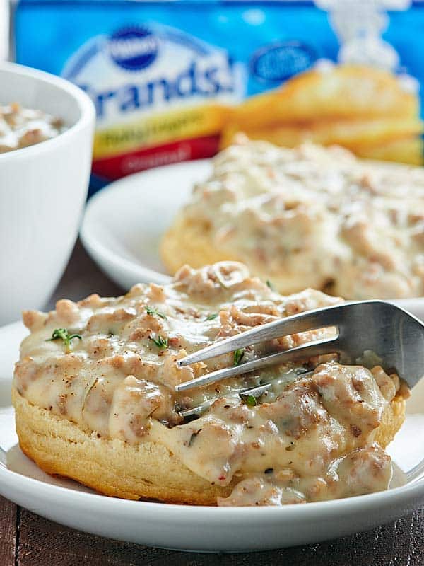 This Easy Biscuits and Gravy recipe is a great, cozy recipe for breakfast or dinner! Pillsbury Grands! get smothered in the creamiest sausage gravy! :) showmetheyummy.com #warmtraditions #sponsored @generalmills @pillsbury