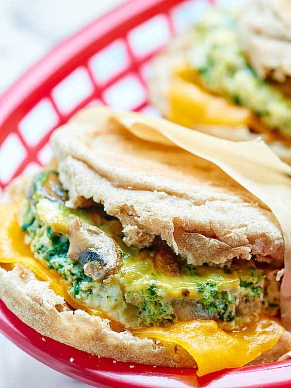 A healthy breakfast sandwich made of eggs, veggies, & optional turkey & cheese! Make these the day of or make them in advance & store in the freezer! showmetheyummy.com #healthy #breakfast