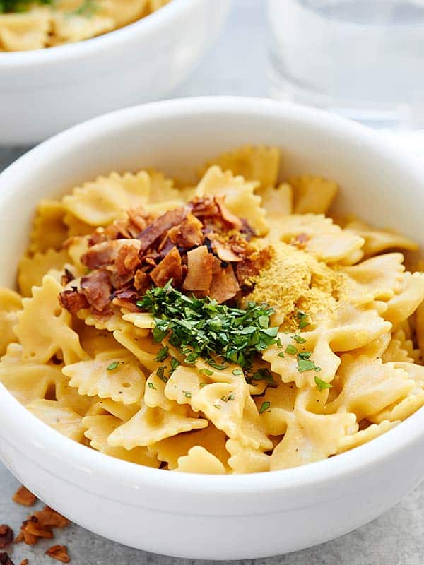 bowl of mac and cheese with coconut bacon and cilantro