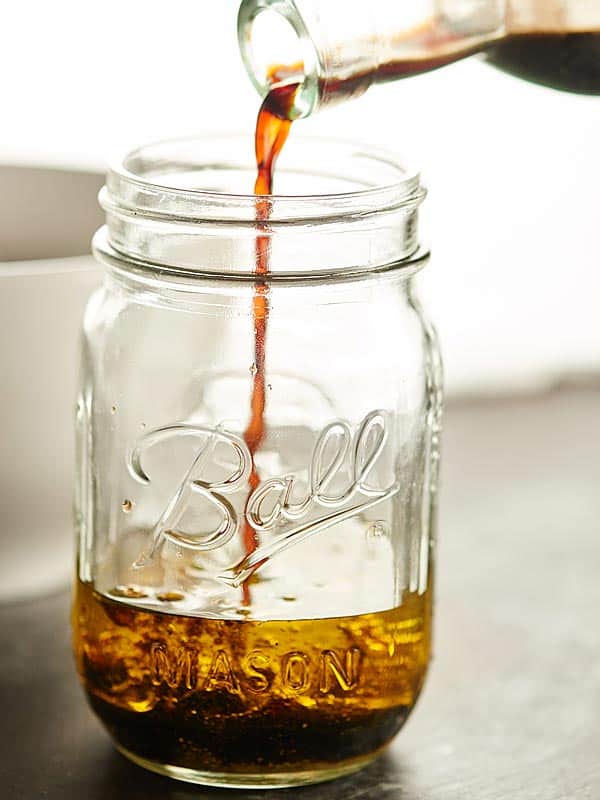 Balsamic vinaigrette being poured into mason jar