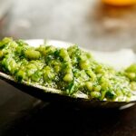 A fun twist on classic pesto, this cilantro pesto recipe is quick and easy, completely delicious, and is full of limes, roasted cashews, garlic, parmesan, and of course, cilantro! This is great over pasta, chicken…anything! showmetheyummy.com #pesto #vegetarian