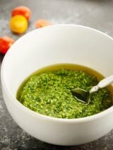 A fun twist on classic pesto, this cilantro pesto recipe is quick and easy, completely delicious, and is full of limes, roasted cashews, garlic, parmesan, and of course, cilantro! This is great over pasta, chicken…anything! showmetheyummy.com #pesto #vegetarian