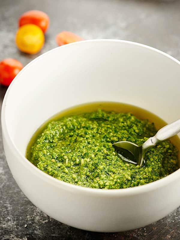 Cilantro pesto in a bowl with spoon