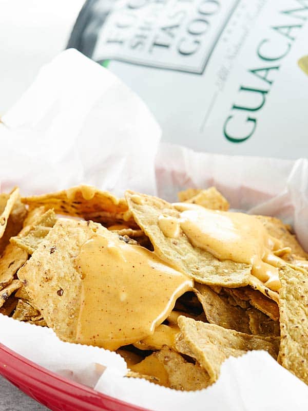 basket of chips with queso dip on top