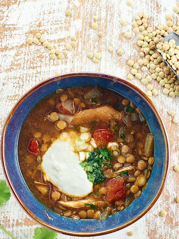 Bowl of slow cooker chicken lentil soup above