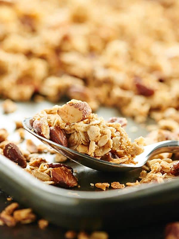 Vegan granola in spoon on baking sheet