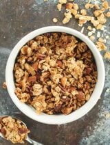 A healthier vegan granola recipe to help satisfy your sweet tooth. This vegan granola is full of good for you ingredients like oats, pecans, and almonds and is naturally sweetened with maple syrup! showmetheyummy.com #vegan #granola