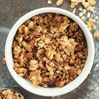 A healthier vegan granola recipe to help satisfy your sweet tooth. This vegan granola is full of good for you ingredients like oats, pecans, and almonds and is naturally sweetened with maple syrup! showmetheyummy.com #vegan #granola
