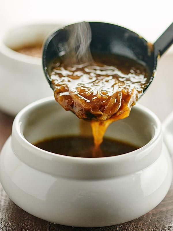 Ladle of soup being put into bowl