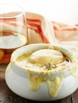This French Onion Soup Recipe is the perfect appetizer for two! A flavorful beef and onion broth is topped with baguette, parmesan, and gooey swiss cheese! showmetheyummy.com #frenchonionsoup #appetizer