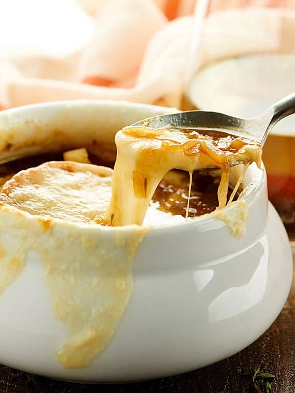 French onion soup bowl with spoon being taken out