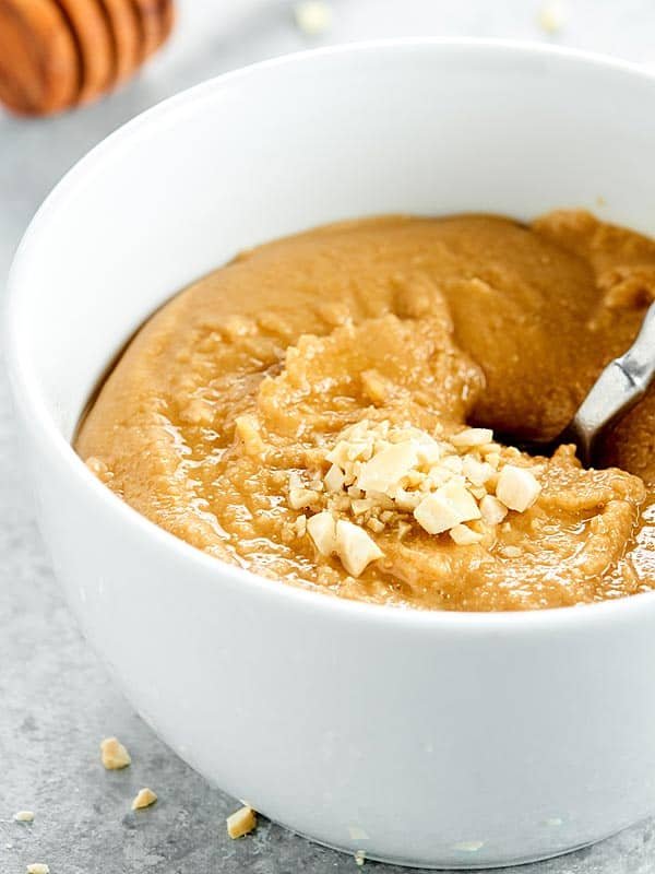 side view bowl of cashew butter with spoon