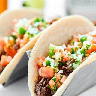 Everything you love about carne asada made easier with a crockpot! This Slow Cooker Carne Asada is so juicy, tender, and topped w/ the best pico de gallo! showmetheyummy.com #carneasada #slowcooker