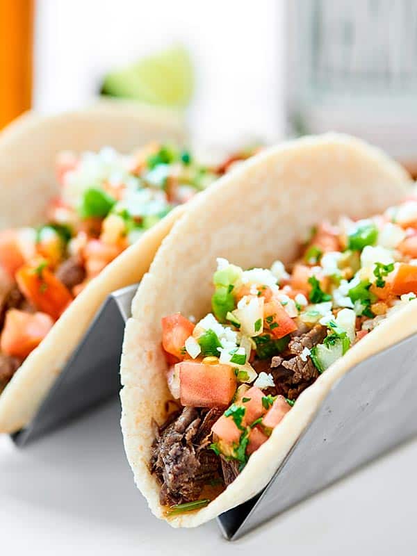 Everything you love about carne asada made easier with a crockpot! This Slow Cooker Carne Asada is so juicy, tender, and topped w/ the best pico de gallo! showmetheyummy.com #carneasada #slowcooker
