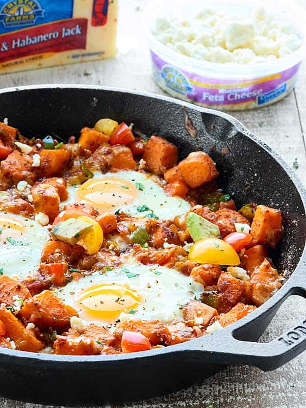 Skillet of hash with Crystal Farms cheeses in the background