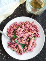 This Beet Pasta Recipe is perfect for spring! Made with fresh beet pasta, lemon juice, a touch of olive oil, arugula, goat cheese, and toasted pine nuts, this pasta is easy, fresh, and delicious! showmetheyummy.com #pasta #vegetarian #pastacrate #ad