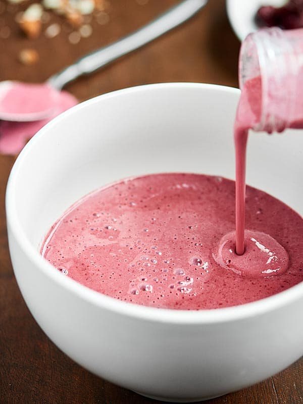 smoothie being poured into bowl