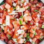 This Easy Pico de Gallo Recipe comes together in a matter of minutes! Fresh tomatoes, onion, cilantro, jalapeno, lime, & garlic make this truly delicious. showmetheyummy.com #picodegallo #healthymexicanfood