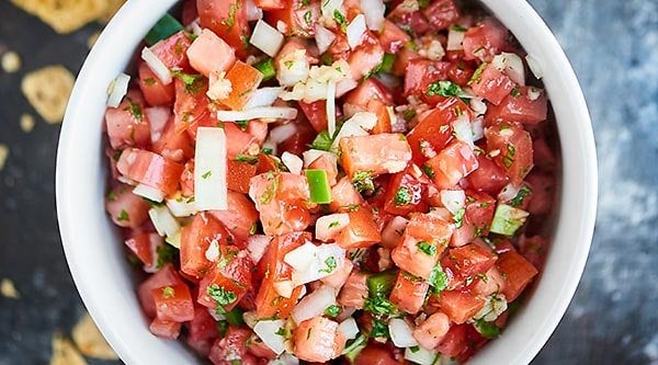 This Easy Pico de Gallo Recipe comes together in a matter of minutes! Fresh tomatoes, onion, cilantro, jalapeno, lime, & garlic make this truly delicious. showmetheyummy.com #picodegallo #healthymexicanfood