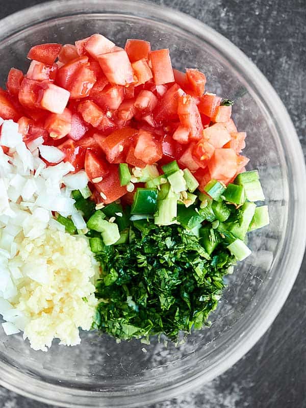 This Easy Pico de Gallo Recipe comes together in a matter of minutes! Fresh tomatoes, onion, cilantro, jalapeno, lime, & garlic make this truly delicious. showmetheyummy.com #picodegallo #healthymexicanfood