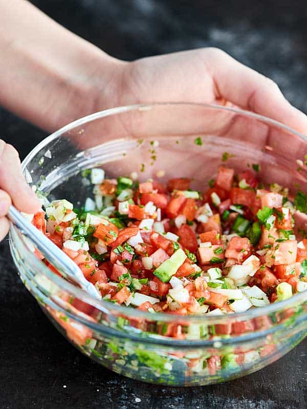 This Easy Pico de Gallo Recipe comes together in a matter of minutes! Fresh tomatoes, onion, cilantro, jalapeno, lime, & garlic make this truly delicious. showmetheyummy.com #picodegallo #healthymexicanfood