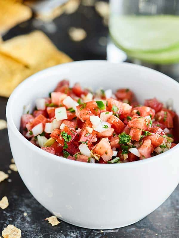 This Easy Pico de Gallo Recipe comes together in a matter of minutes! Fresh tomatoes, onion, cilantro, jalapeno, lime, & garlic make this truly delicious. showmetheyummy.com #picodegallo #healthymexicanfood