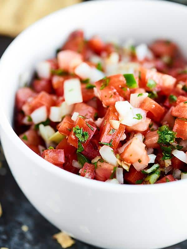 This Easy Pico de Gallo Recipe comes together in a matter of minutes! Fresh tomatoes, onion, cilantro, jalapeno, lime, & garlic make this truly delicious. showmetheyummy.com #picodegallo #healthymexicanfood