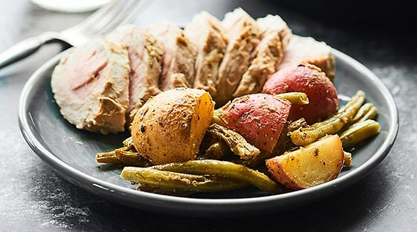 Baked pork tenderloin at it's finest! This Lemon Herb Pork Tenderloin Recipe is healthy, easy, & full of fresh spring flavors like lemon, dijon, & garlic! showmetheyummy.com #porktenderloin #springrecipe