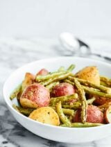 This Roasted Potatoes and Green Beans Recipe is my new, go-to spring side dish! Potatoes are paired w/ green beans & smothered in a lemon mustard dressing. showmetheyummy.com #roastedpotatoes #greenbeans