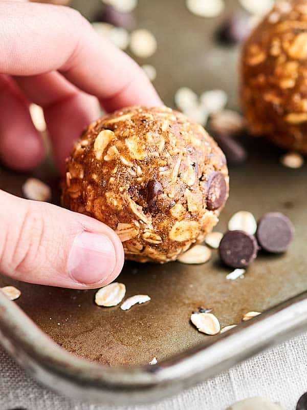 Almond butter energy bite being picked up off tray