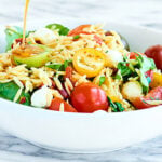 This Caprese Pasta Salad is so quick and easy to put together! Full of orzo pasta, mozzarella, sun dried tomatoes, fresh basil, tangy balsamic, and salty parmesan! showmetheyummy.com #pastasalad #caprese