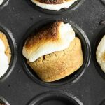 SMores Cookie Cups. A simple graham cracker cookie is stuffed with a melty hershey’s kiss, topped with a marshmallow, and gets toasted to golden perfection! showmetheyummy.com #smores #cookie
