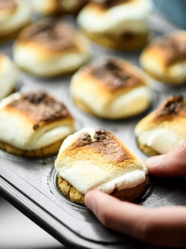 smores cookie cup being taken out of muffin tin