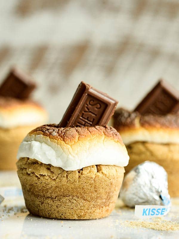 smores cookie cup topped with roasted marshmallow and piece of chocolate