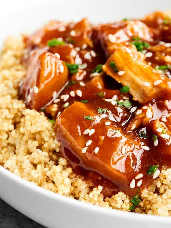 closeup of chicken over quinoa with sesame seeds