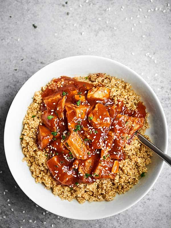 honey sriracha chicken over quinoa in a bowl overhead