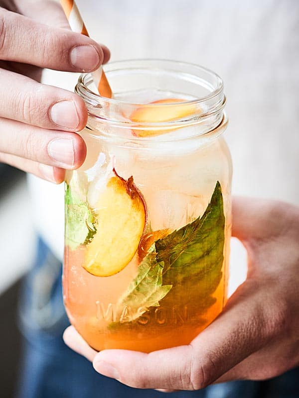 peach lemonade spritzer in mason jar held