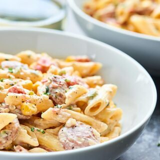 A completely gluten free pasta dish, this Spicy Chicken Sausage Pasta Recipe is full of gluten free penne, chicken apple sausage, veggies, and the creamiest sauce! showmetheyummy.com Recipe made in partnership with Aidells & Barilla. @AidellsSausage #EmbraceYourFoodie #ad