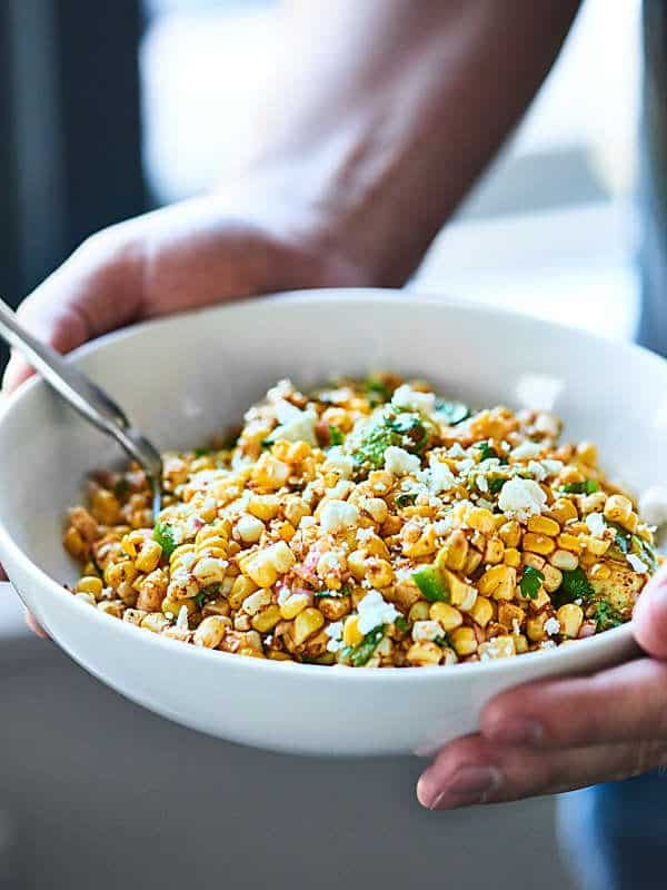 bowl of mexican corn salad held