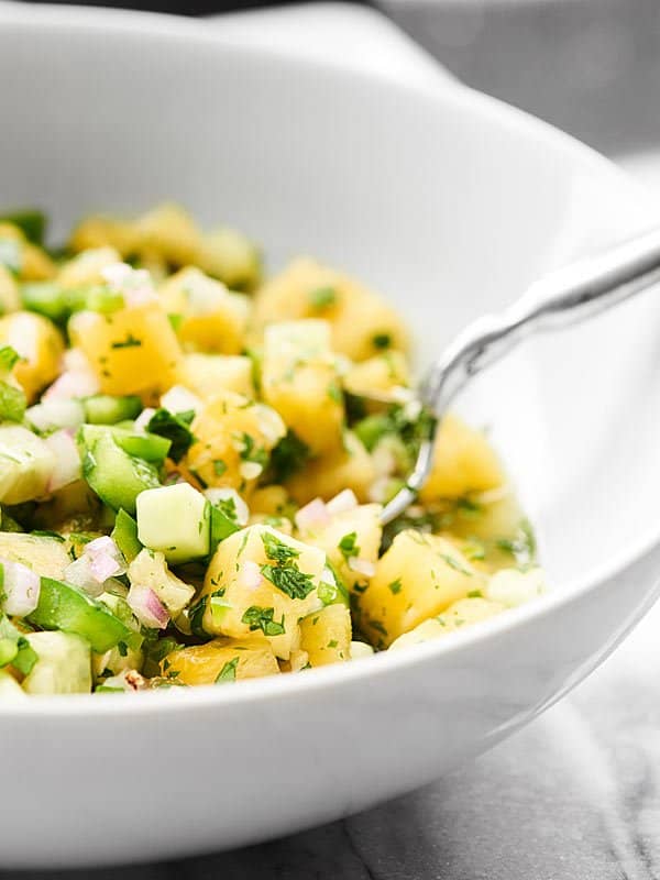 This Pineapple Salsa is full of juicy pineapple, crunchy bell peppers, cooling cucumbers and more to make the perfect sweet, spicy, crunchy salsa ever! showmetheyummy.com #pineapple #salsa