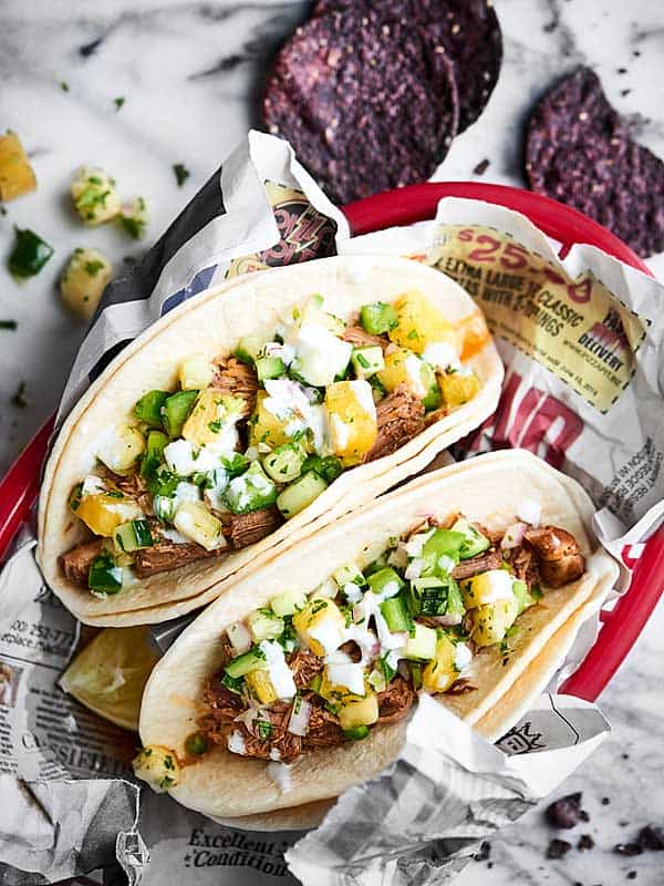 two tacos filled with crockpot carnitas