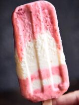Strawberry Coconut Popsicles, my favorite summer treat! Full of greek yogurt and fresh fruit, the ingredient list is short, the popsicles are creamy dreamy, and you better believe they're healthy enough to enjoy without the guilt! showmetheyummy.com #popsicles #greekyogurt