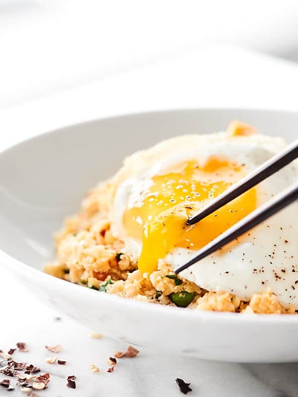 bowl of cauliflower fried rice with chopsticks