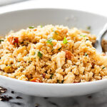 This Cauliflower Fried Rice is SO healthy and full of veggies. It comes together in about 20 minutes and is totally customizable. Keep it vegan or add your protein of choice: ooey egg, chicken, shrimp, you name it! showmetheyummy.com #cauliflower #cauliflowerfriedrice