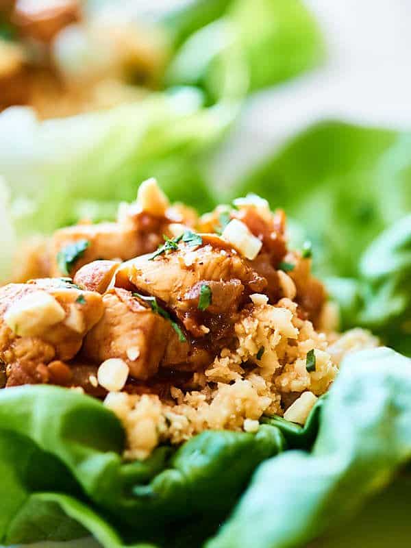 Have a few for a light lunch, or half the recipe for a filling and healthy dinner, these Healthy Asian Lettuce Wraps are full of tender chicken, a crazy flavorful sauce, and loads of texture! showmetheyummy.com #lettucewraps #asianlettucewraps